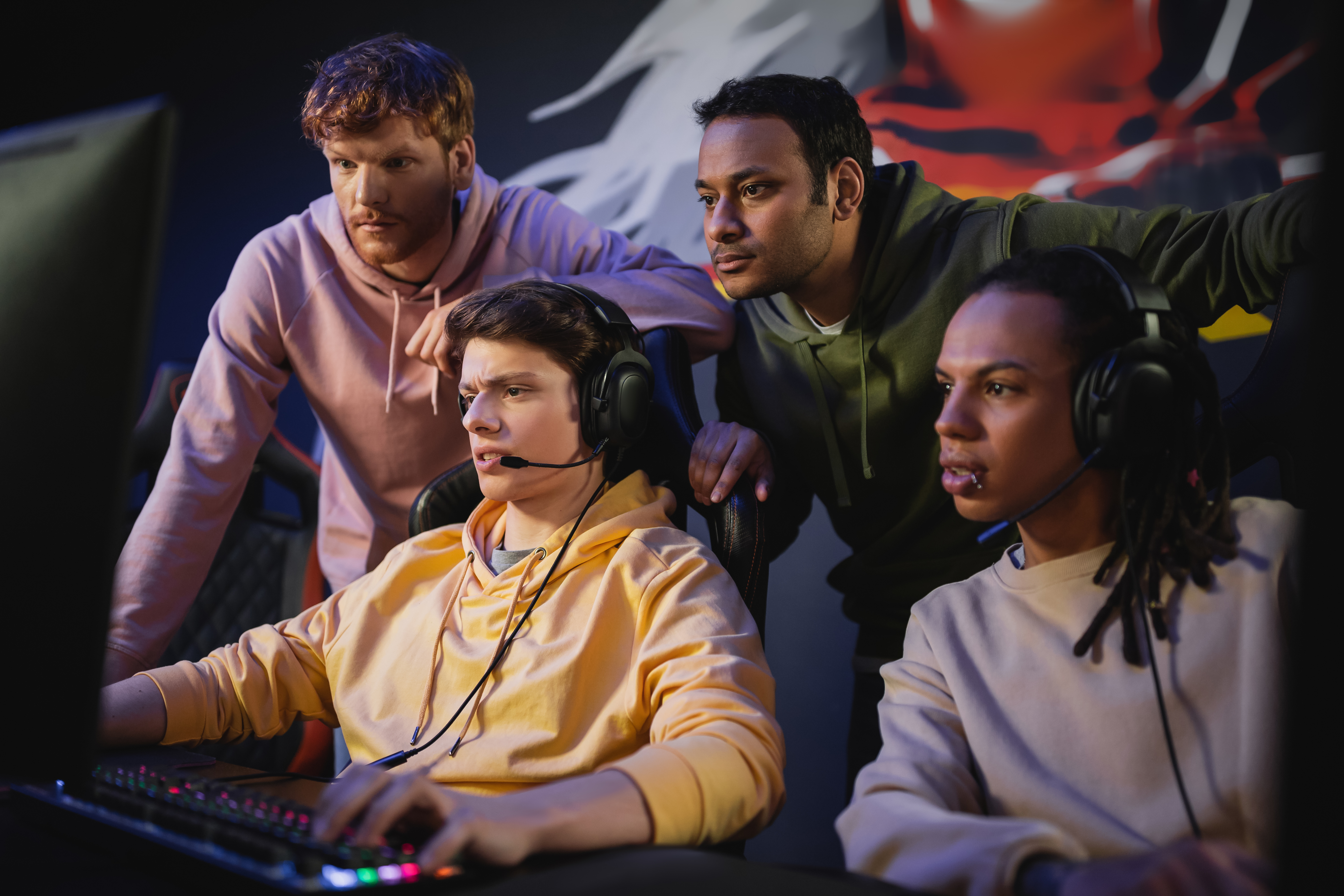 multiethnic-team-standing-near-friend-playing-vide-2026-03-11-03-21-53-utc