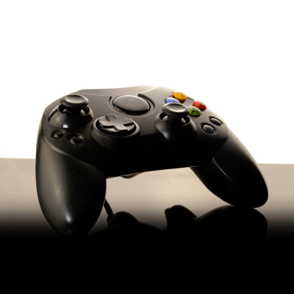 video-game-controller-on-reflective-black-surface-2026-03-26-11-42-54-utc (1)